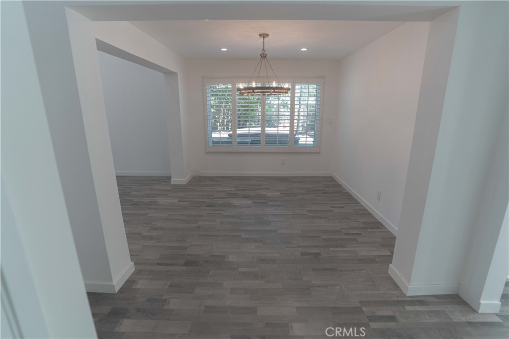 12230 Stewarton Drive Porter Ranch, CA 91326 - Photo 9 of 37 wooden floor in an empty room with a window