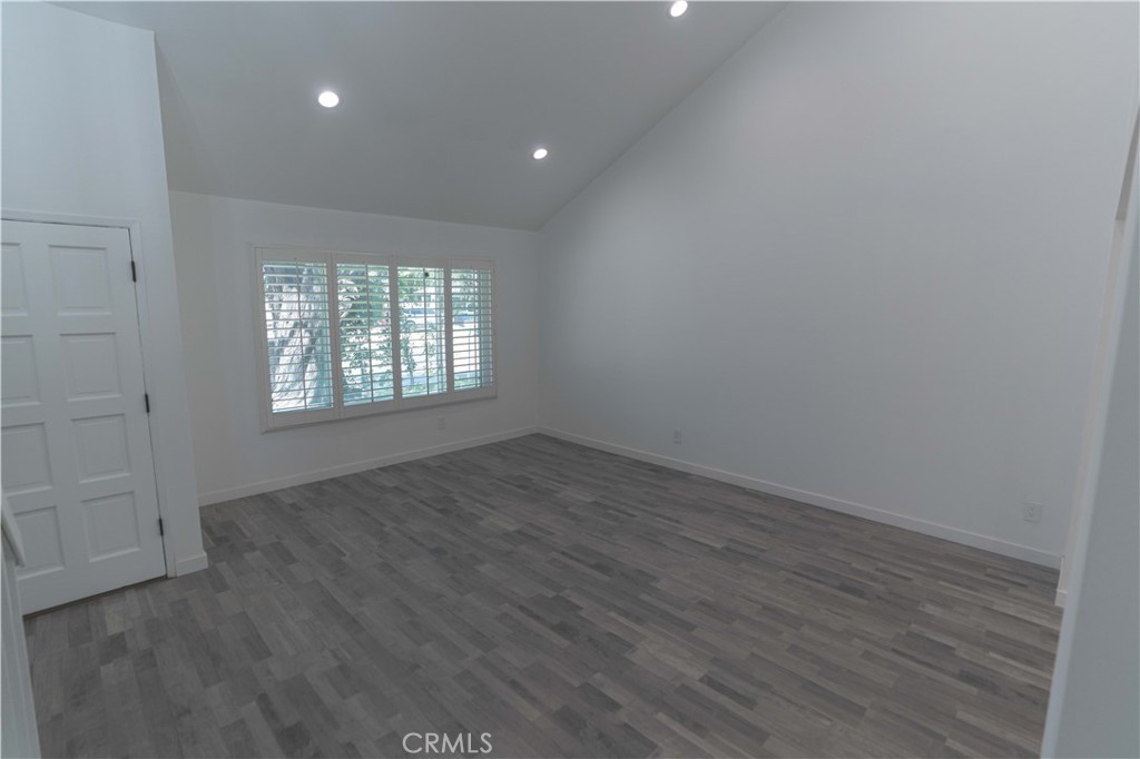 12230 Stewarton Drive Porter Ranch, CA 91326 - Photo 10 of 37 an empty room with wooden floor and windows