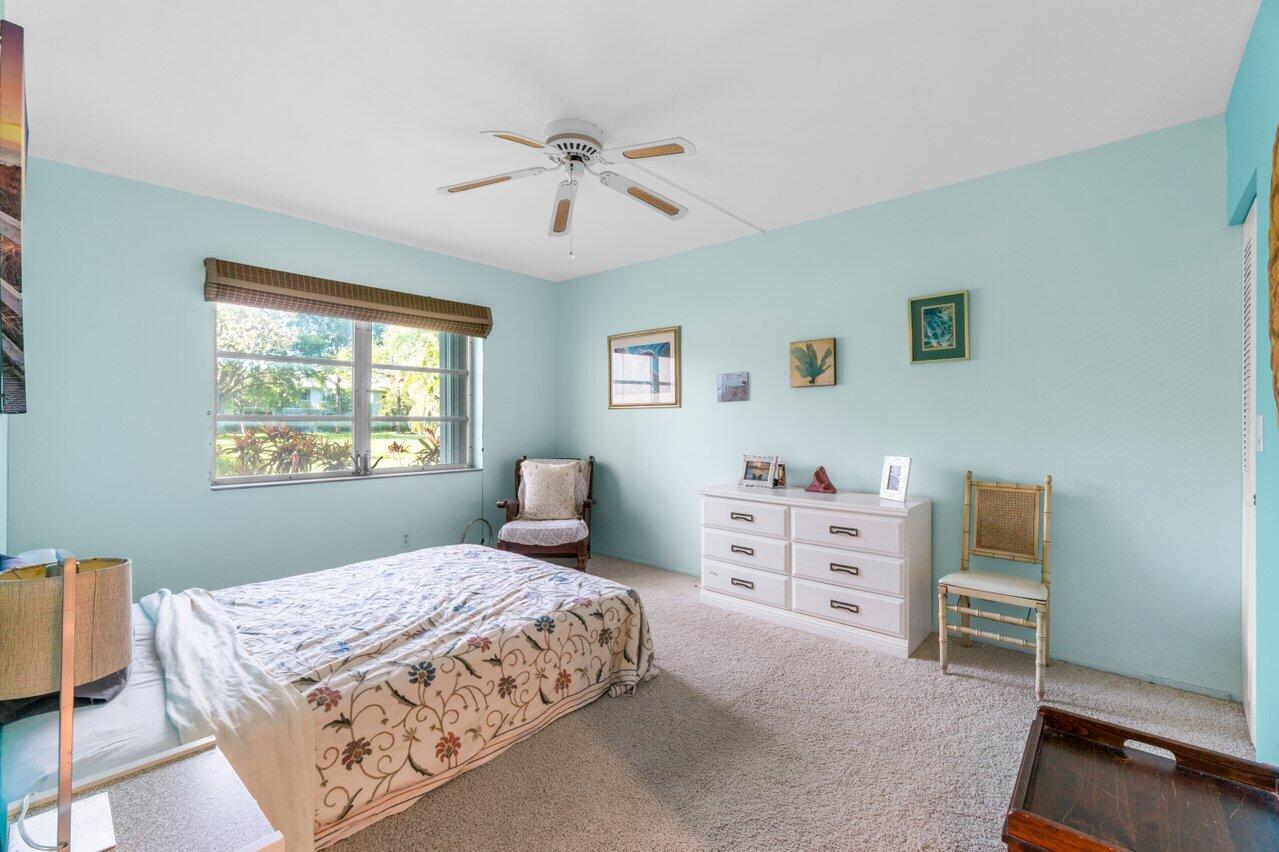 2460 Southwest 22nd Avenue, Unit 809 Delray Beach, FL 33445 - Photo 13 of 27 a bedroom with a bed and a dresser in it