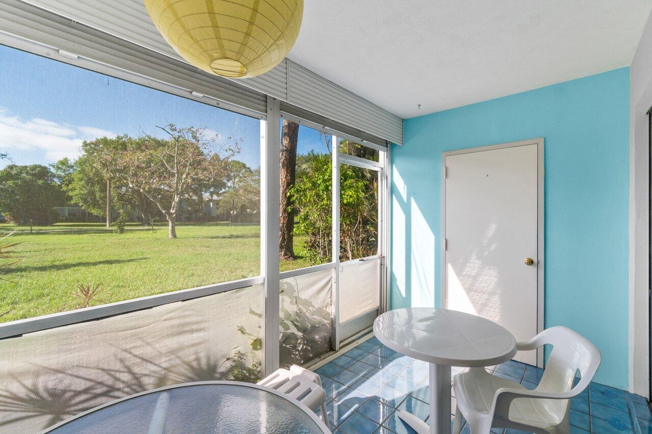 2460 Southwest 22nd Avenue, Unit 809 Delray Beach, FL 33445 - Photo 18 of 27 a view of a porch with furniture and a yard