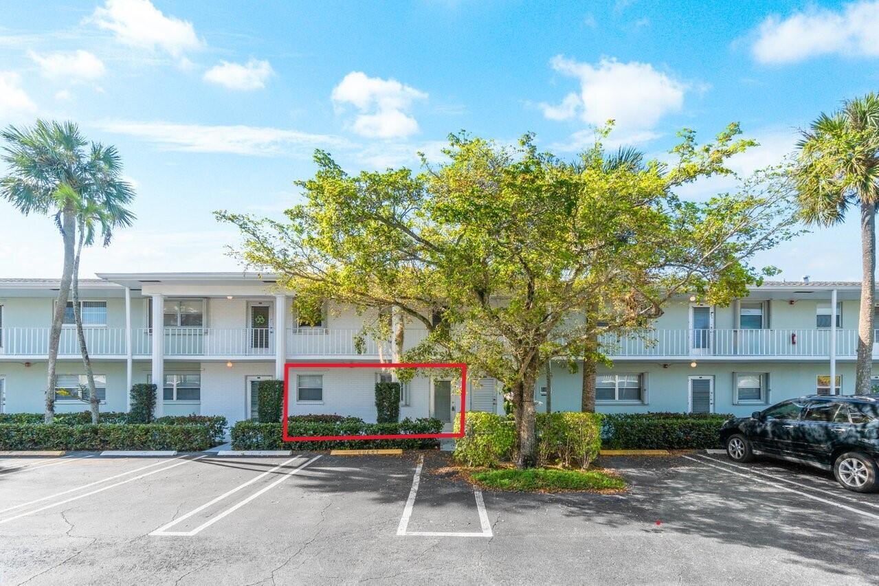2460 Southwest 22nd Avenue, Unit 809 Delray Beach, FL 33445 - Photo 21 of 27 a front view of a building with garden