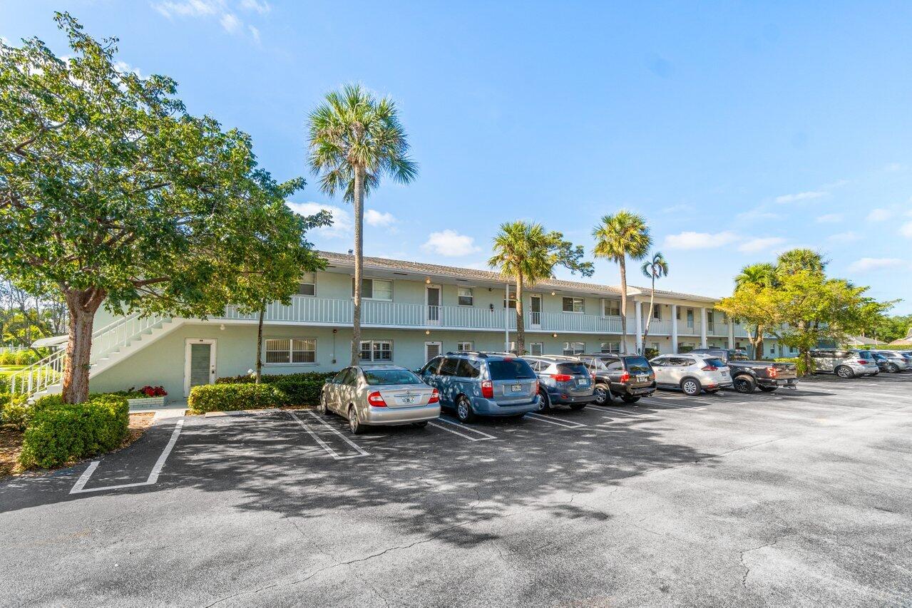 2460 Southwest 22nd Avenue, Unit 809 Delray Beach, FL 33445 - Photo 22 of 27 a car parked in front of a building