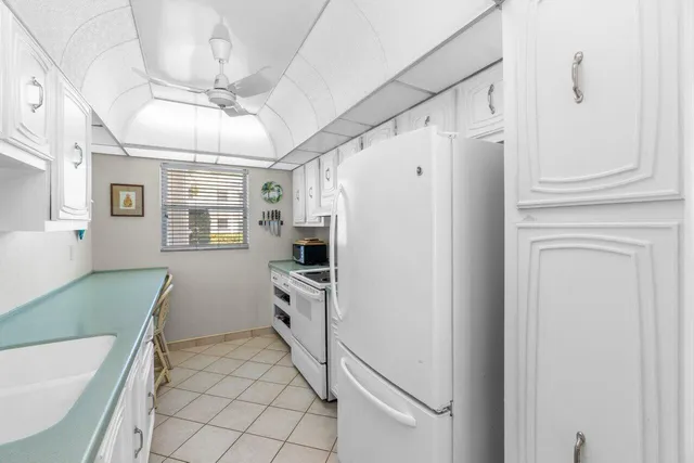 a kitchen with stainless steel appliances a refrigerator sink and cabinets