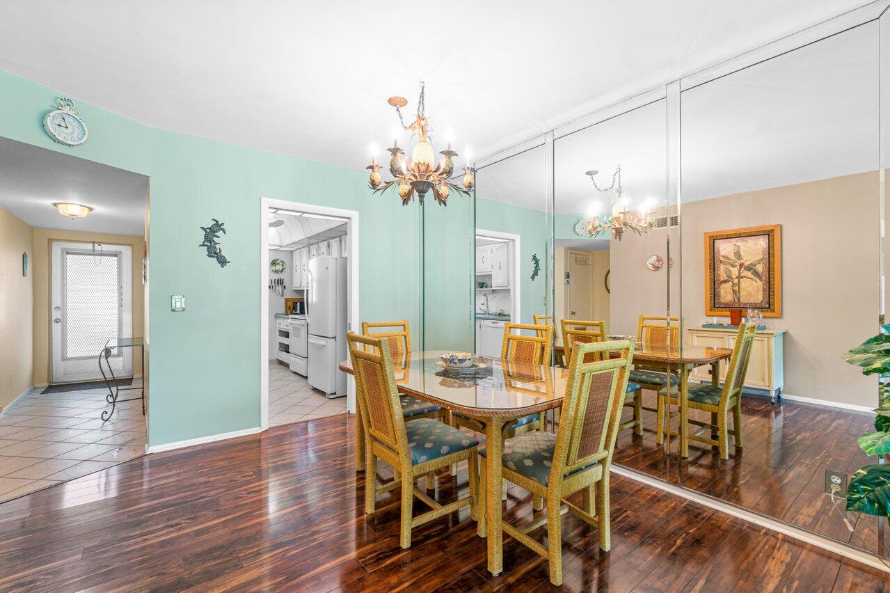 2460 Southwest 22nd Avenue, Unit 809 Delray Beach, FL 33445 - Photo 7 of 27 a view of a dining room with furniture and wooden floor