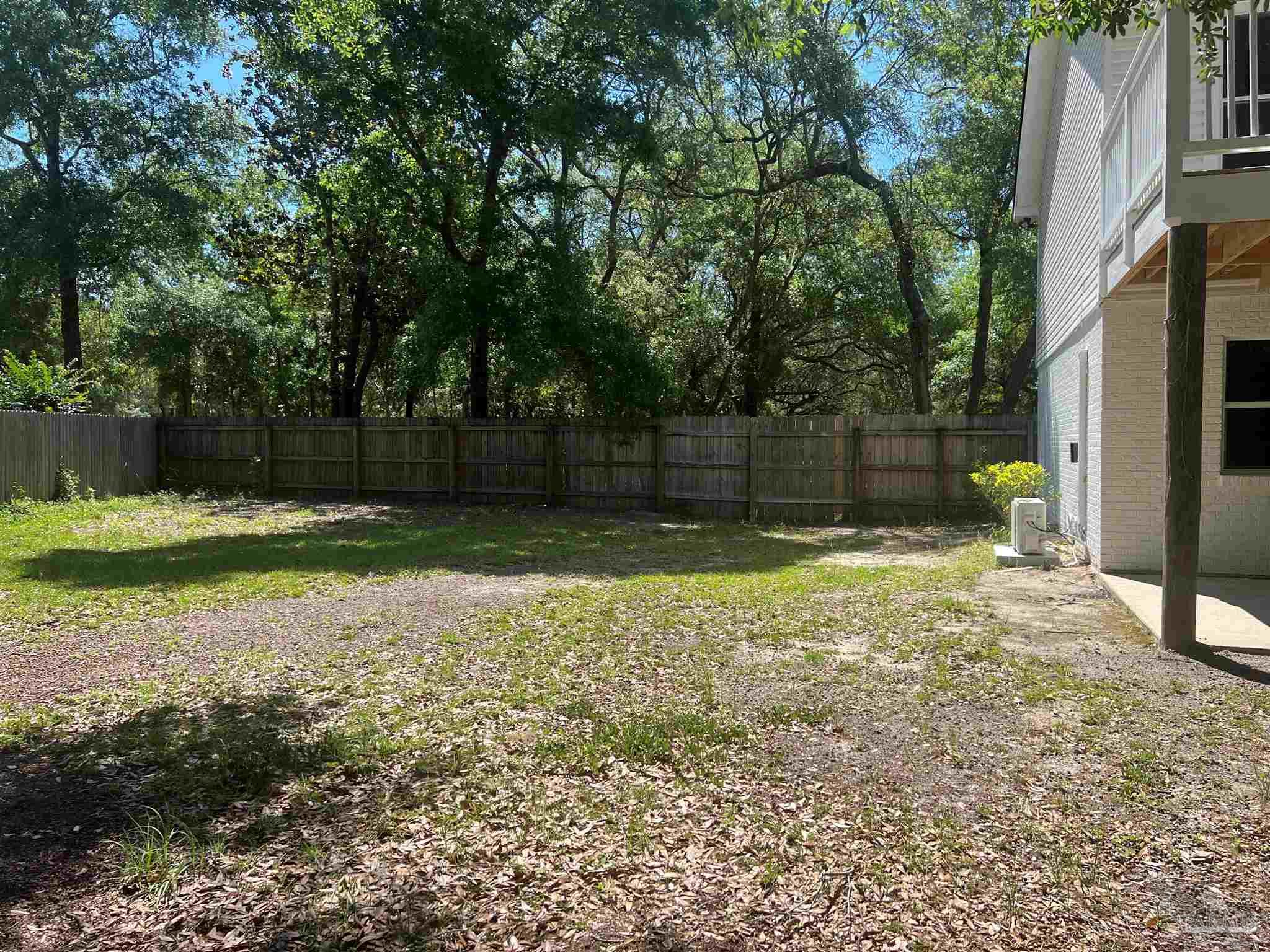 3111 Holley Point Road Navarre, FL 32566 - Photo 22 of 23 a view of a backyard with a trees