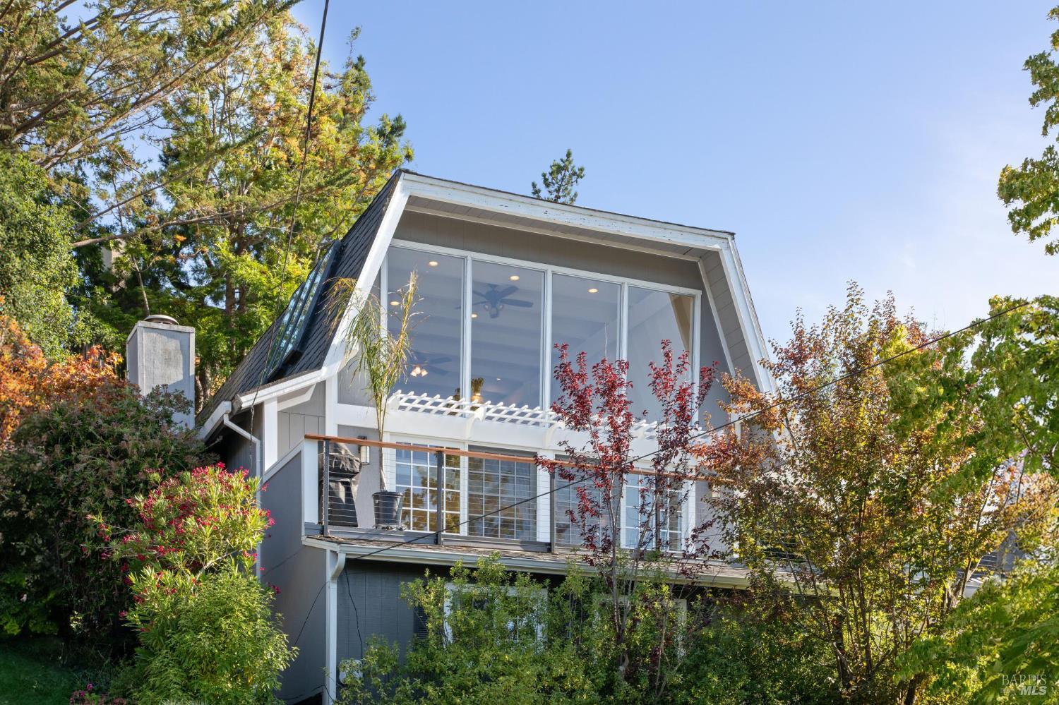 a front view of house along with trees