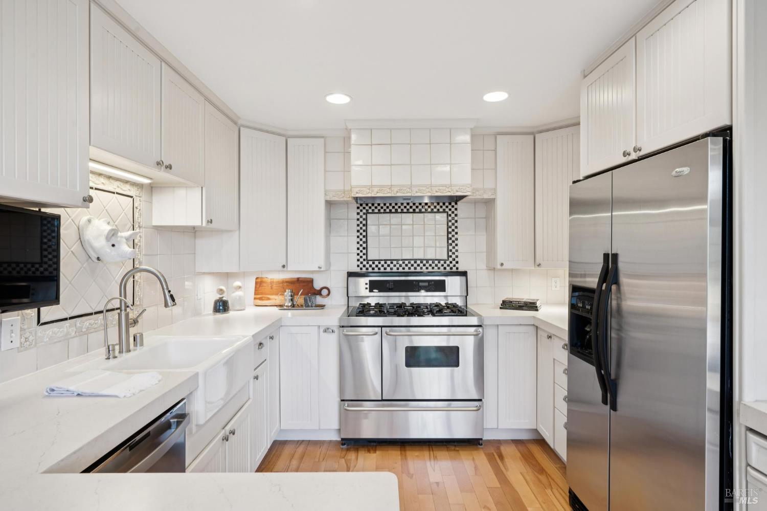 347 Jewell Street San Rafael, CA 94901 - Photo 41 of 61 a kitchen with a sink a refrigerator and a stove top oven with wooden floor