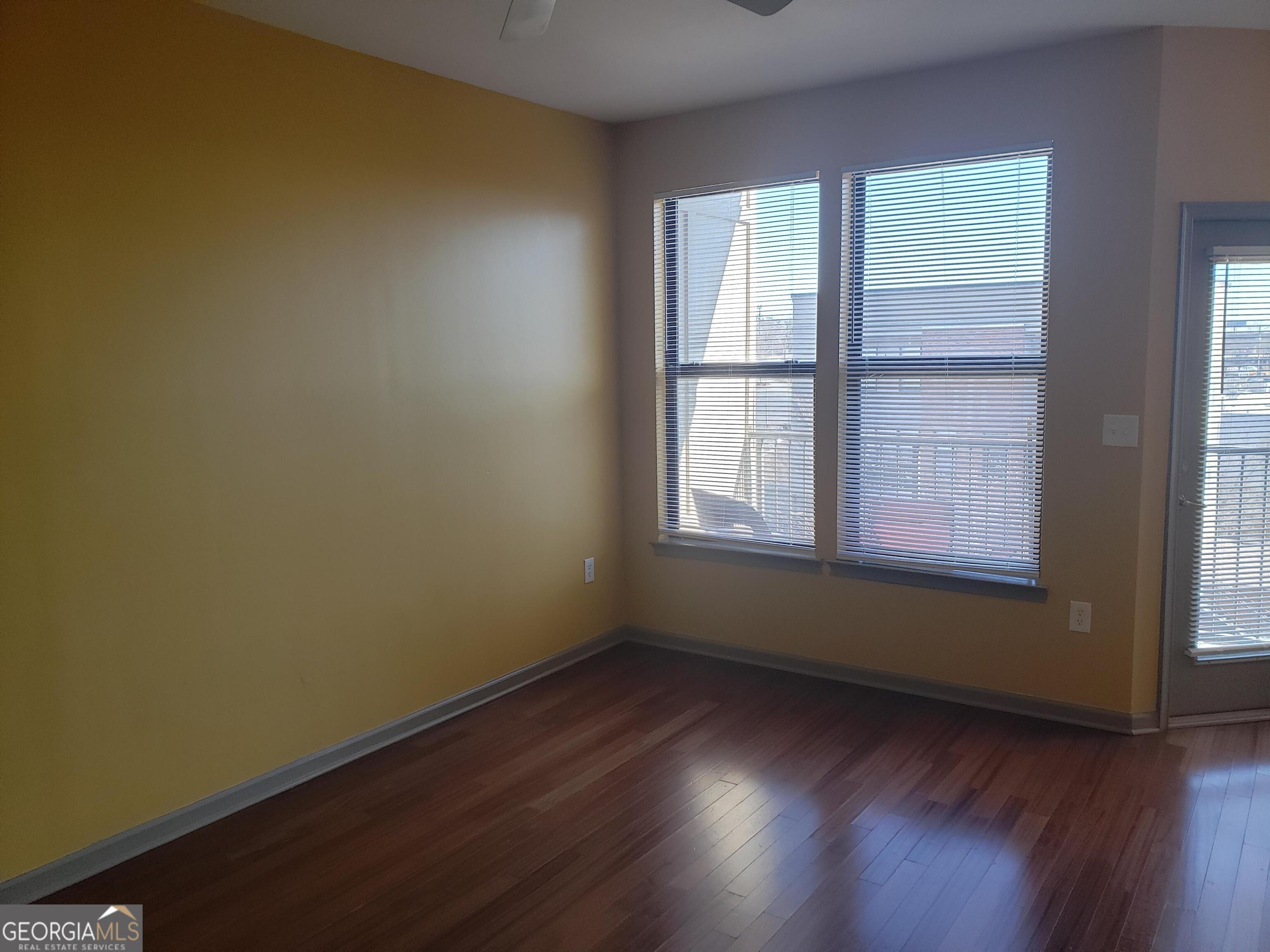 898 Oak Street Southwest, Unit 1303 Atlanta, GA 30310 - Photo 6 of 17 an empty room with wooden floor and windows