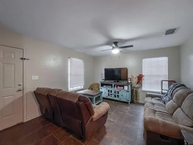 a living room with furniture and a flat screen tv