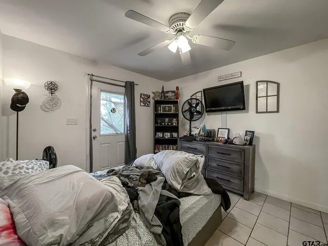 a bedroom with a bed and a flat screen tv