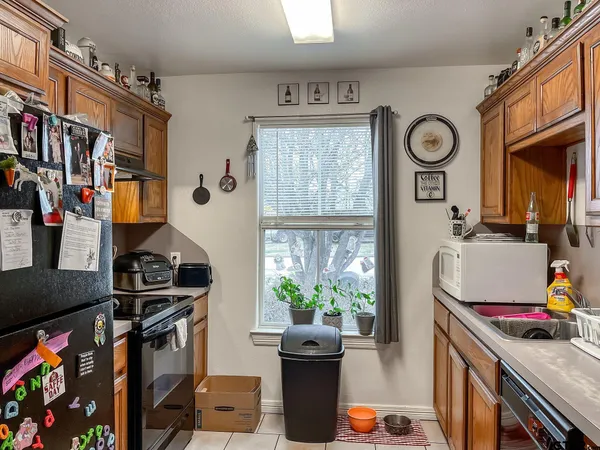 a view of a storage and utility room with fridge and lots of stuff