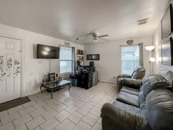 a living room with furniture and a flat screen tv
