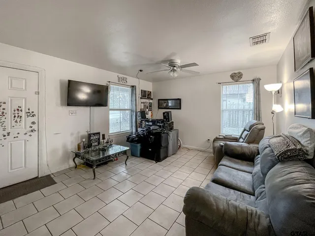 a living room with furniture and a flat screen tv