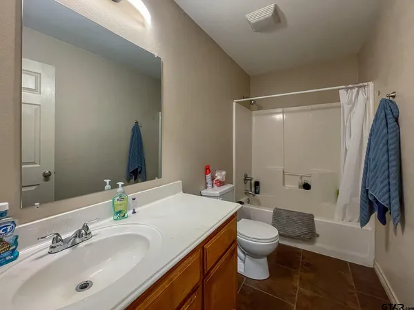 a bathroom with a double vanity sink toilet and shower