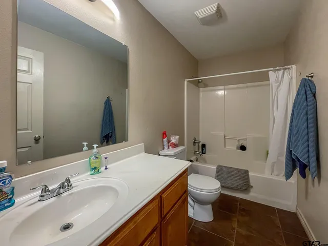 a bathroom with a double vanity sink toilet and shower
