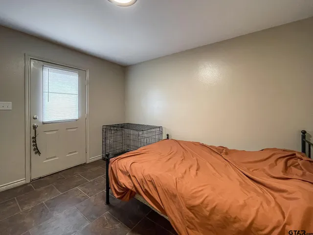 a bed sitting in a bedroom next to a window
