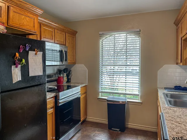 a kitchen with refrigerator and window