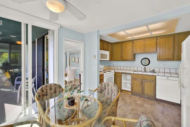 a view of a dining room with furniture and a window