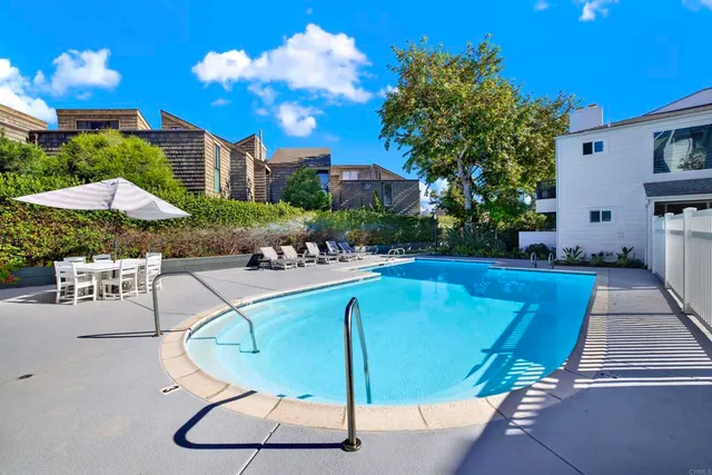 a view of a balcony with flower plants