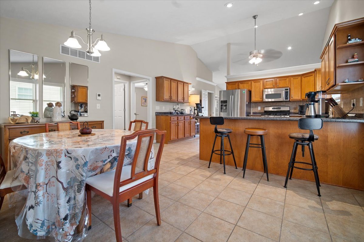 1600 Belclare Road Normal, IL 61761 - Photo 11 of 40 a dining table chairs and a kitchen view