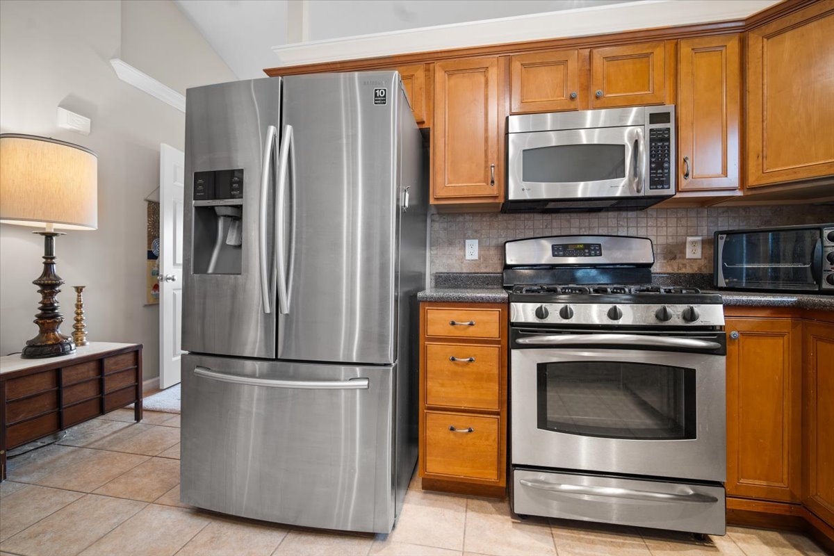 1600 Belclare Road Normal, IL 61761 - Photo 16 of 40 a kitchen with stainless steel appliances granite countertop a stove a refrigerator and a microwave