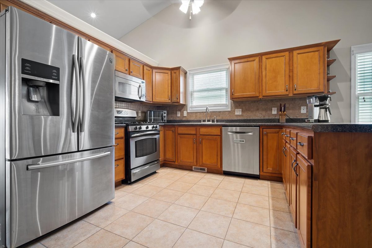 1600 Belclare Road Normal, IL 61761 - Photo 18 of 40 a kitchen with stainless steel appliances granite countertop a refrigerator sink and cabinets
