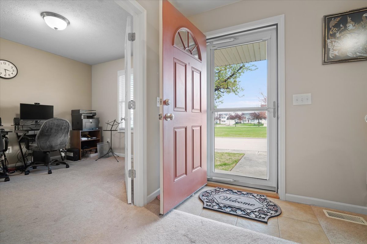 1600 Belclare Road Normal, IL 61761 - Photo 30 of 40 a view of a hallway to a livingroom with furniture and a window