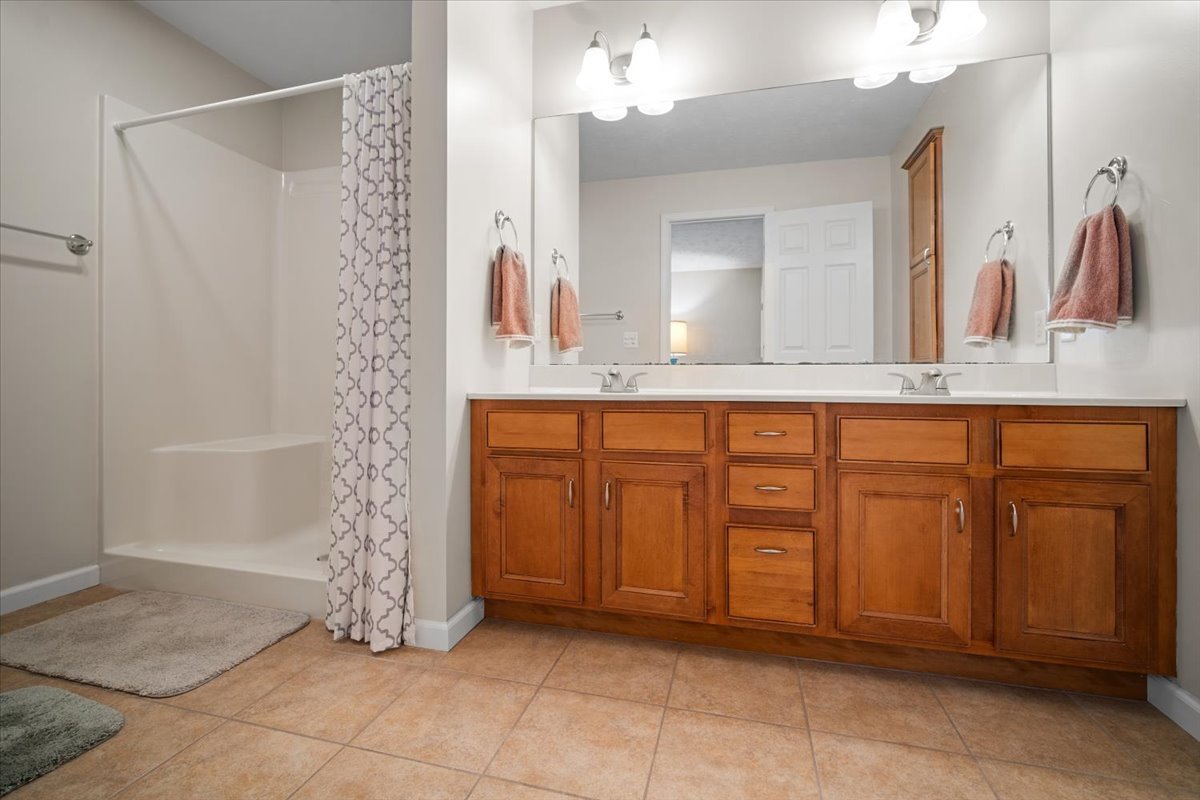 1600 Belclare Road Normal, IL 61761 - Photo 6 of 40 a bathroom with a sink a mirror and a shower