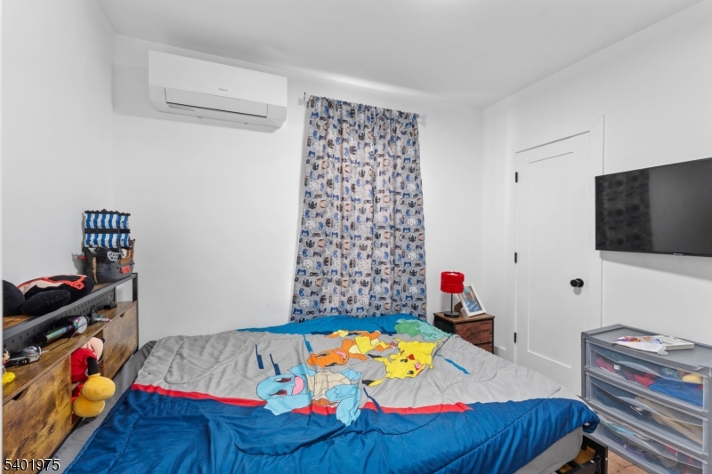 123 Jaques Street Elizabeth, NJ 07201 - Photo 11 of 20 a bedroom with a bed and wooden floor