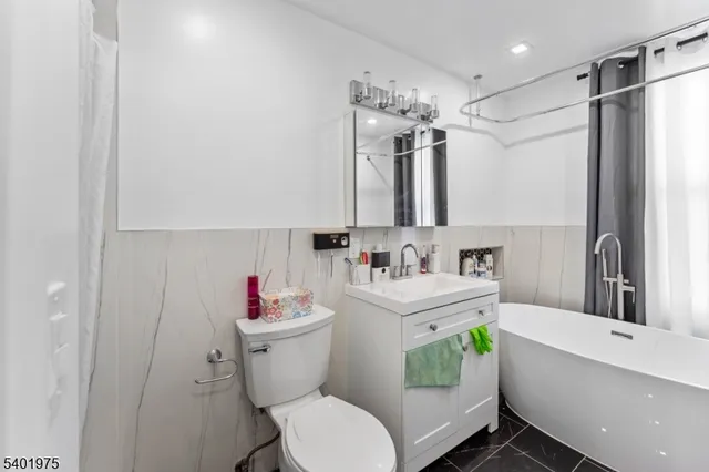 a bathroom with a sink toilet mirror and shower