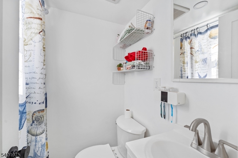 123 Jaques Street Elizabeth, NJ 07201 - Photo 8 of 20 a bathroom with a toilet sink and mirror