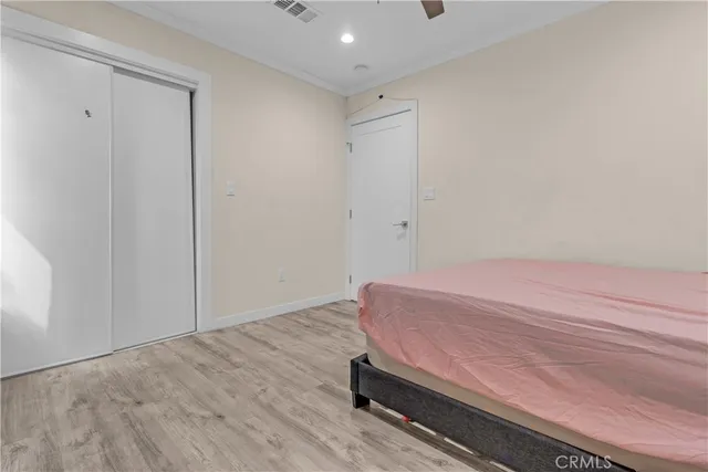 a room with a bed and wooden floor