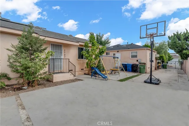 a view of a house with a patio and a yard