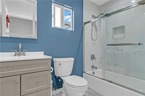 a bathroom with a granite countertop toilet sink and a shower