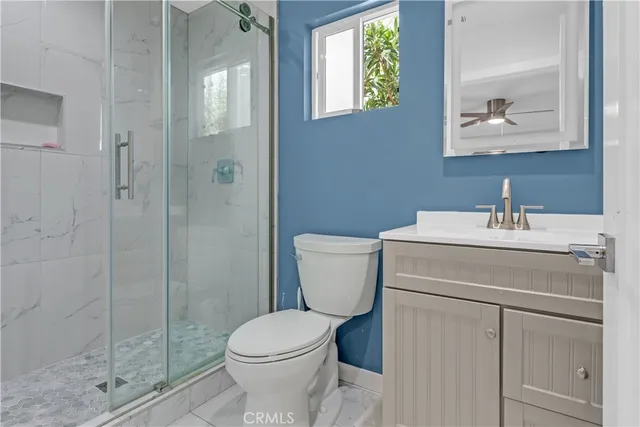 a bathroom with a toilet sink and shower