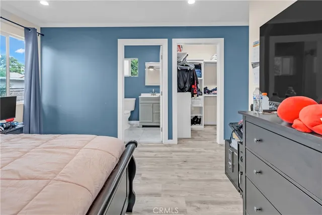 a room with a bed and a mirror on dresser