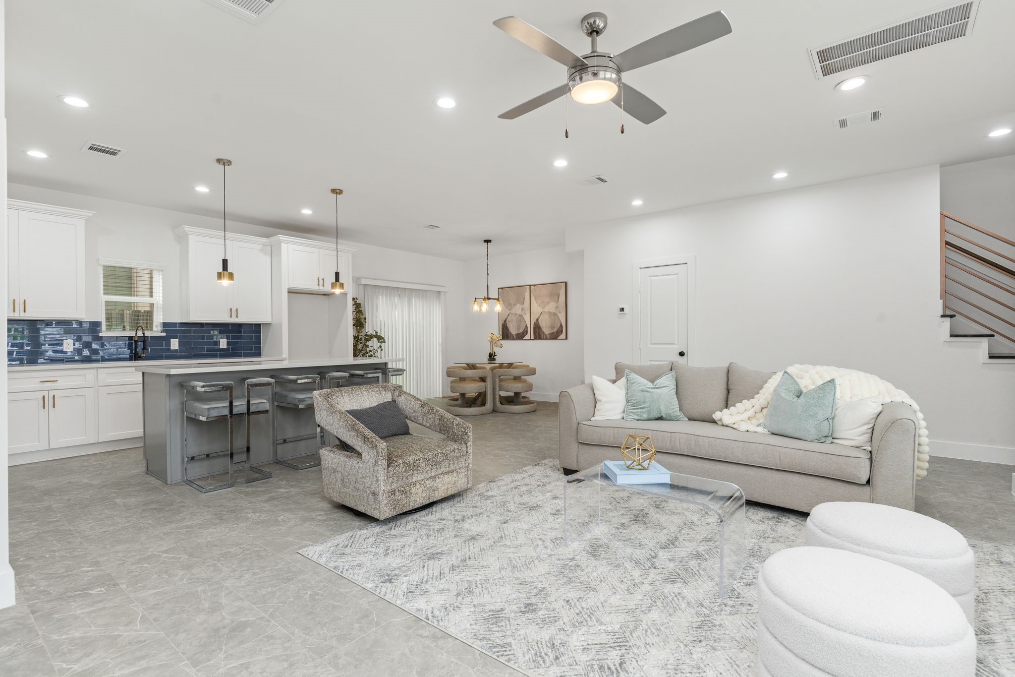 a living room with furniture and kitchen view