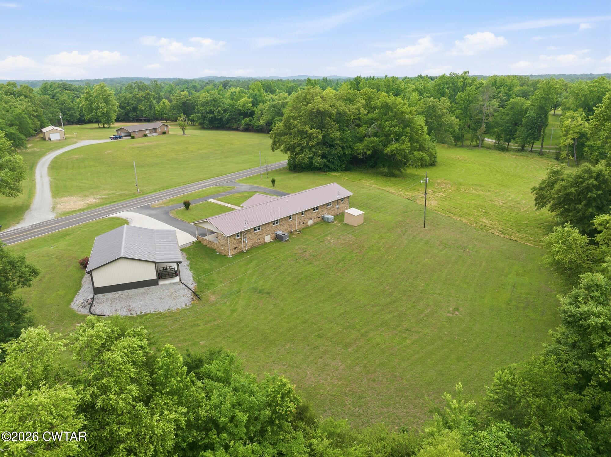 944 Brooksie Thompson Road Decaturville, TN 38329 - Photo 5 of 47 an aerial view of a residential houses with outdoor space and trees all around