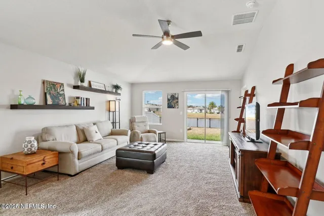 a living room with furniture and kitchen view