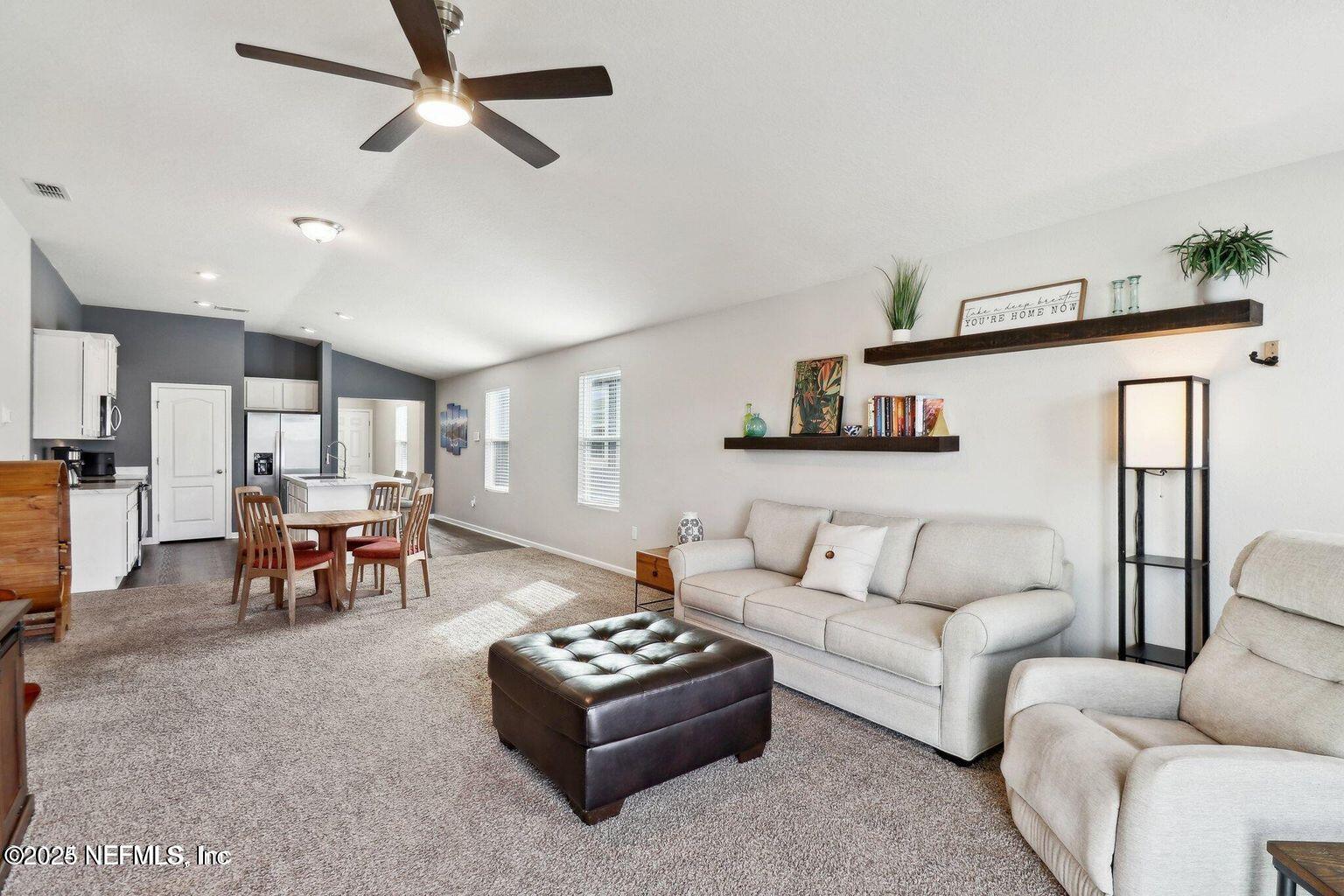 2535 Acorn Creek Road Green Cove Springs, FL 32043 - Photo 12 of 26 a living room with furniture and kitchen view