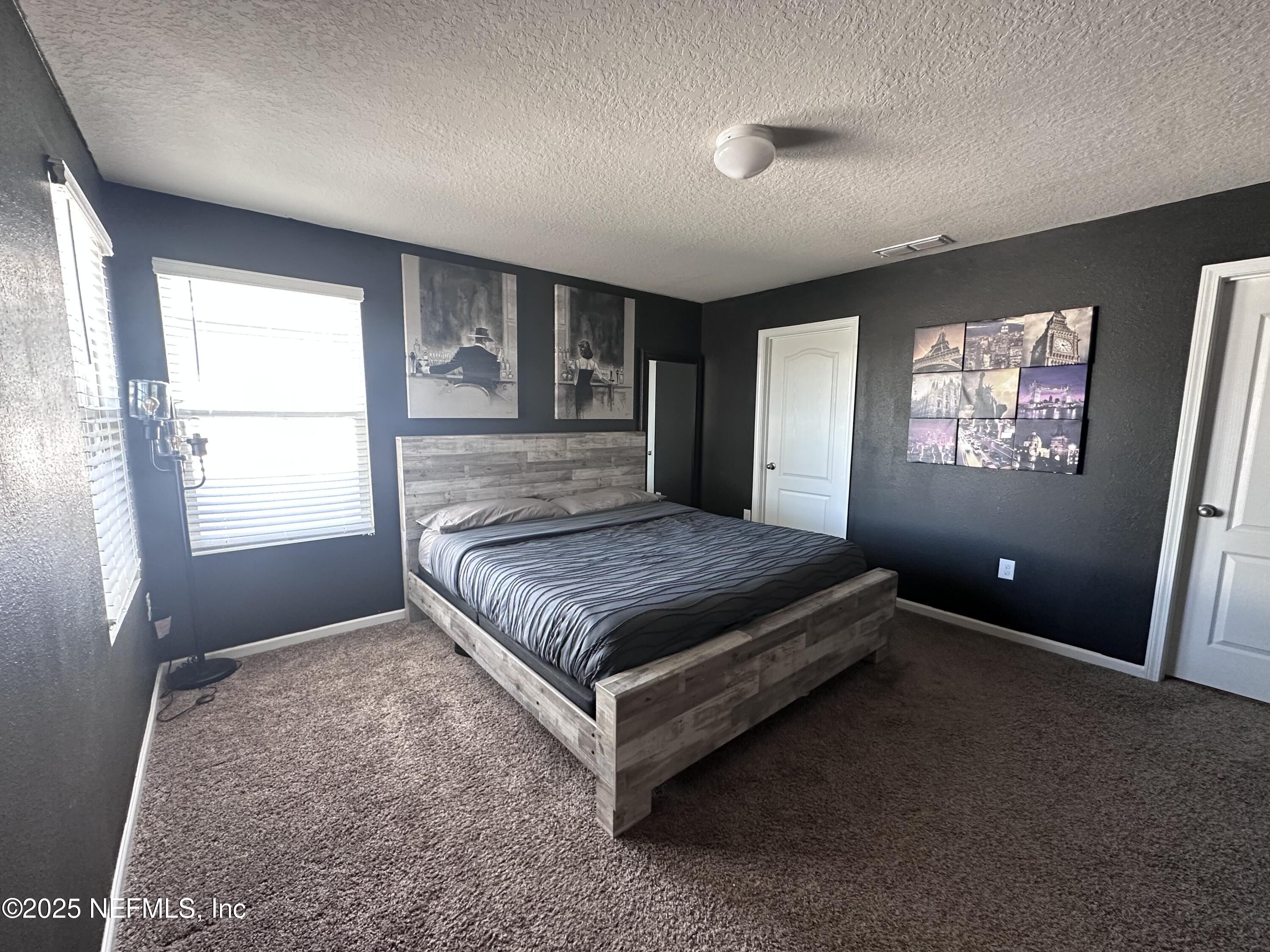 2535 Acorn Creek Road Green Cove Springs, FL 32043 - Photo 18 of 26 a bedroom with a bed and window