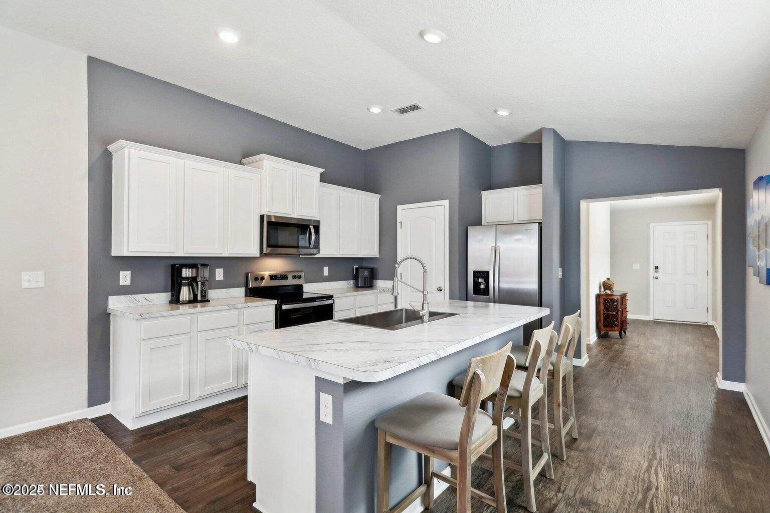 2535 Acorn Creek Road Green Cove Springs, FL 32043 - Photo 7 of 26 a kitchen with a sink a microwave and cabinets