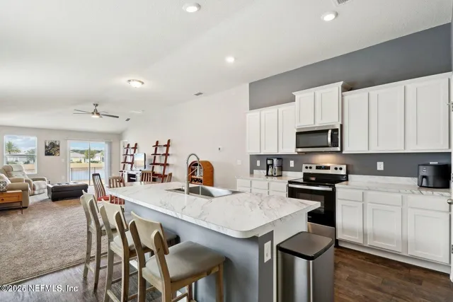 a kitchen with a stove a refrigerator and a sink