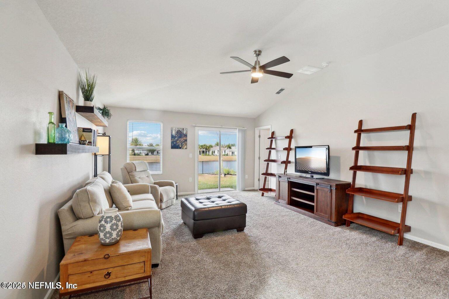 2535 Acorn Creek Road Green Cove Springs, FL 32043 - Photo 10 of 26 a living room with furniture and a flat screen tv