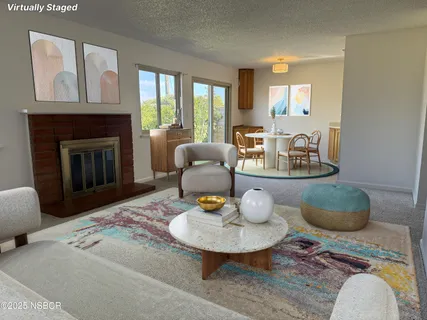 a view of a livingroom with a fireplace and window