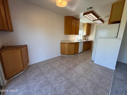 a kitchen with metallic refrigerator freezer and a dishwasher