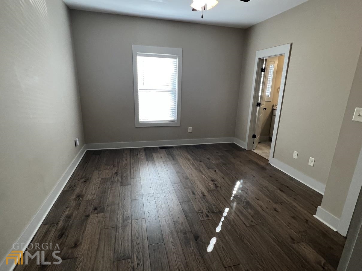 860 South Harkness Street, Unit G Jackson, GA 30233 - Photo 11 of 21 an empty room with wooden floor and windows