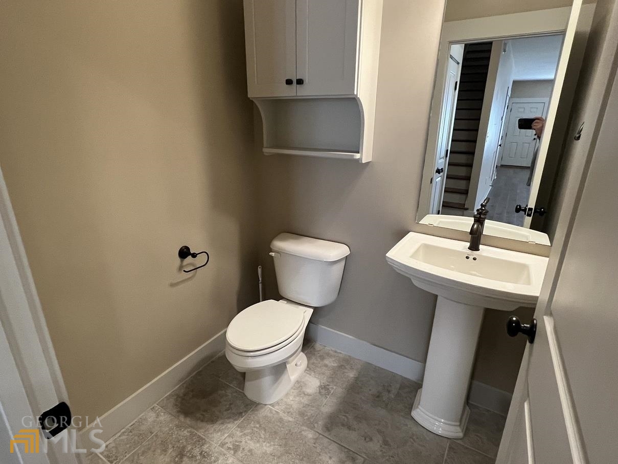 860 South Harkness Street, Unit G Jackson, GA 30233 - Photo 21 of 21 a bathroom with a sink toilet and a mirror