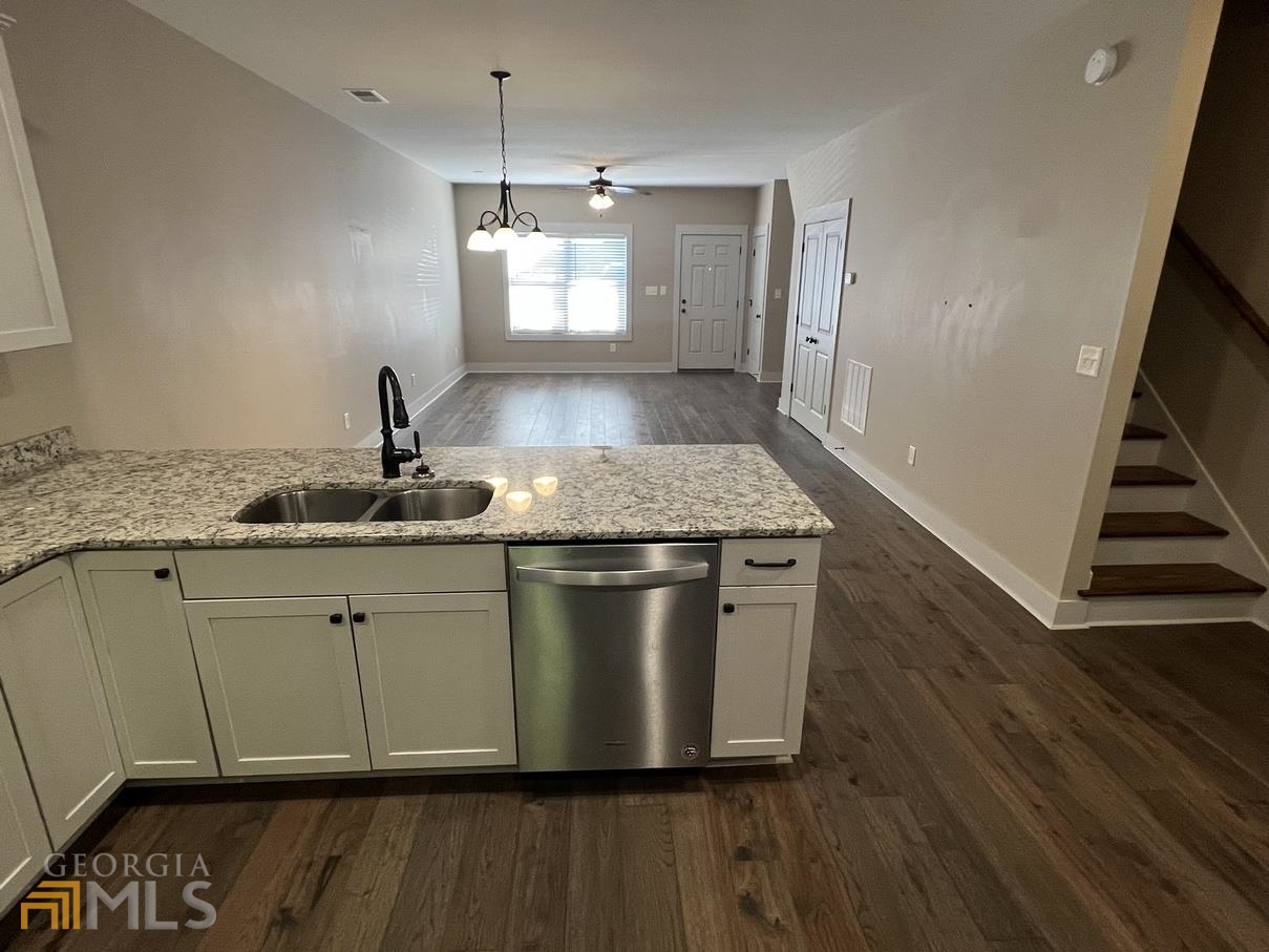 860 South Harkness Street, Unit G Jackson, GA 30233 - Photo 9 of 21 a kitchen with a sink and wooden floor