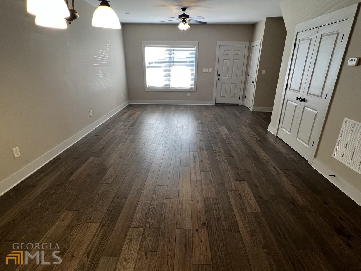 860 South Harkness Street, Unit G Jackson, GA 30233 - Photo 10 of 21 wooden floor in an empty room with a window